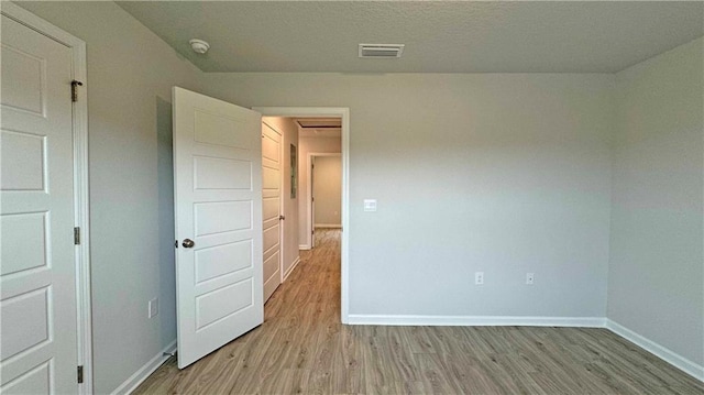 empty room with light hardwood / wood-style floors