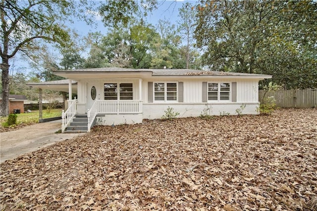 view of front of property with covered porch and a carport