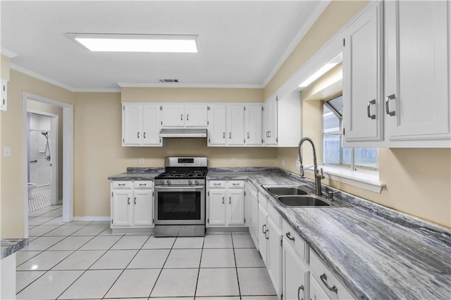 kitchen with white cabinets, stainless steel gas stove, sink, and crown molding