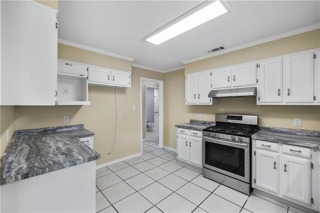kitchen with light tile patterned floors, stainless steel gas stove, ornamental molding, and white cabinets