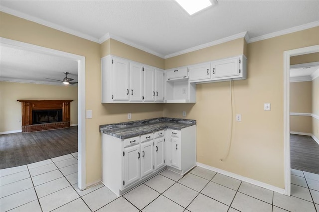 kitchen featuring white cabinetry, light wood-type flooring, and ornamental molding