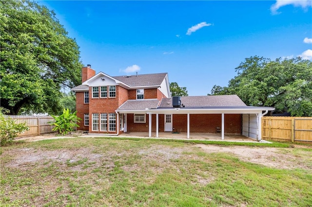 back of property featuring a yard and a patio area