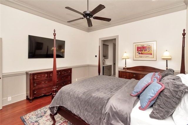 bedroom with hardwood / wood-style flooring, ornamental molding, and ceiling fan