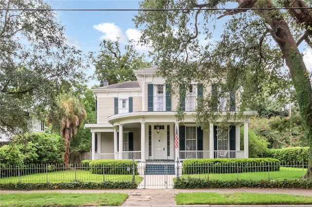 view of front of home with a porch and a front yard