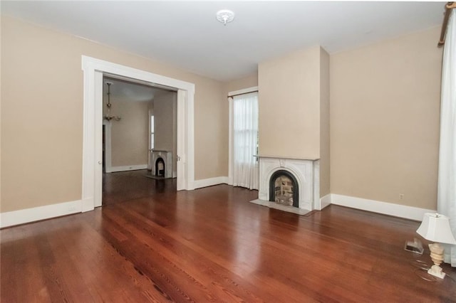 unfurnished living room with hardwood / wood-style flooring