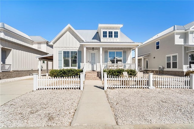 view of front facade featuring board and batten siding, metal roof, and a porch