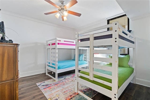 bedroom with dark wood finished floors, crown molding, baseboards, and ceiling fan