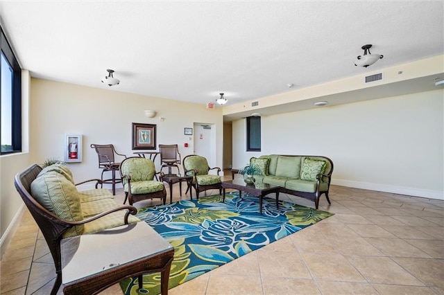 living area featuring visible vents, baseboards, and light tile patterned floors