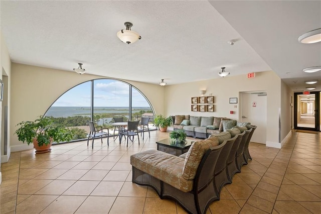 living area with light tile patterned flooring and baseboards