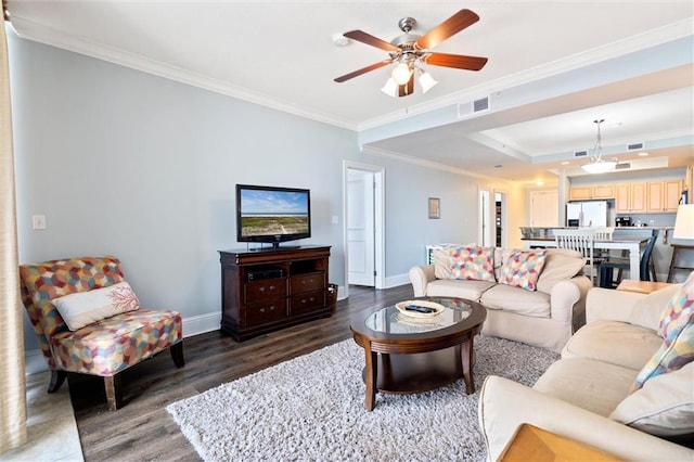 living area featuring crown molding, visible vents, dark wood-type flooring, ceiling fan, and baseboards