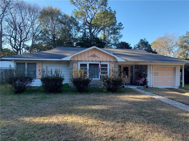 single story home with a garage and a front lawn