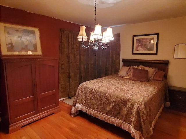 bedroom with an inviting chandelier and wood-type flooring