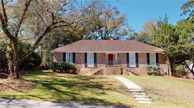 single story home with brick siding and a front lawn