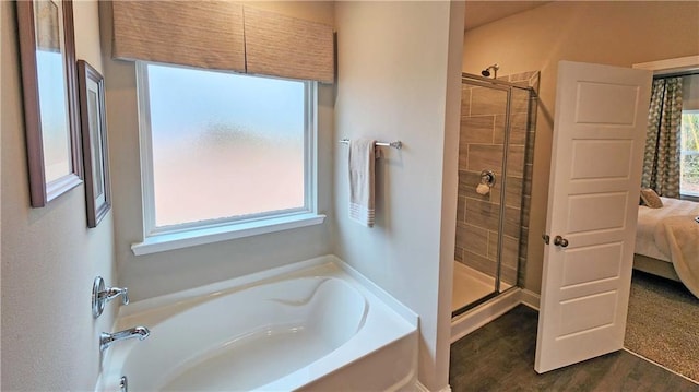 9851 Nadine Ln, Mobile, AL 36695 - ensuite bathroom featuring a bath, a shower stall, and wood finished floors