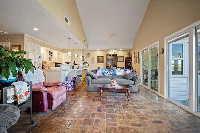 living room featuring ceiling fan and high vaulted ceiling