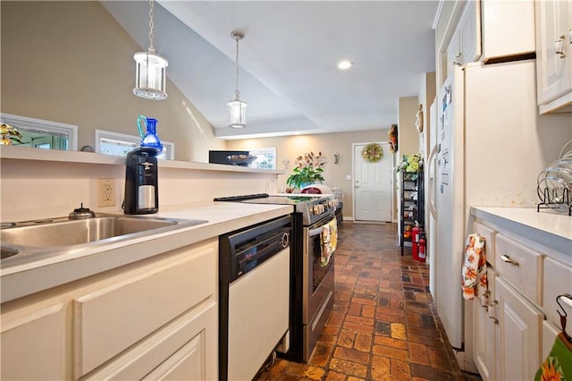 kitchen featuring white appliances, decorative light fixtures, and sink