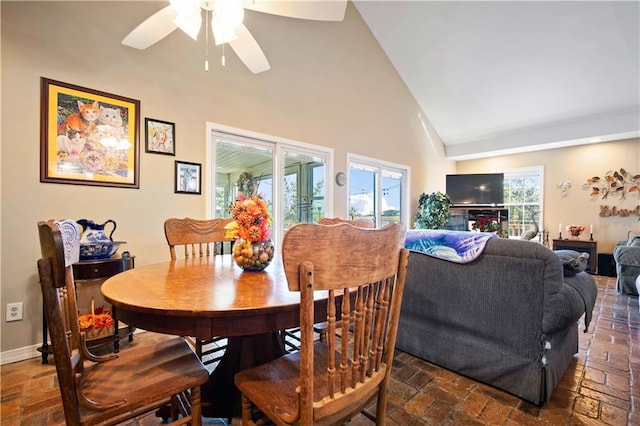 dining room with high vaulted ceiling and ceiling fan