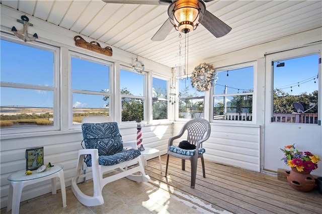 sunroom / solarium with wood ceiling and ceiling fan