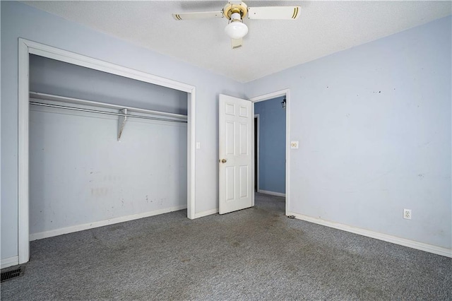 unfurnished bedroom featuring dark colored carpet, a closet, and ceiling fan