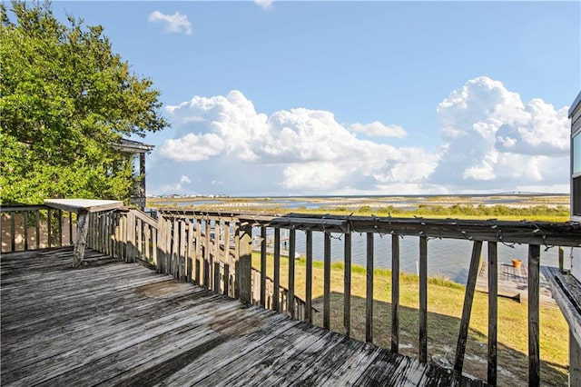 wooden deck featuring a water view