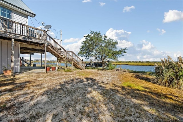 view of yard featuring a deck with water view