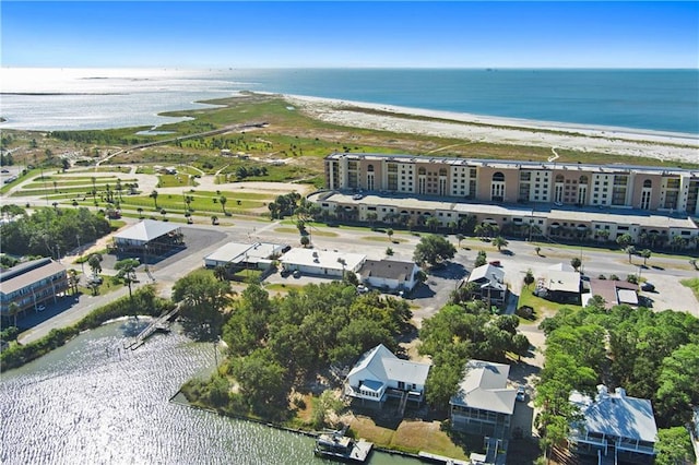 birds eye view of property featuring a water view and a beach view