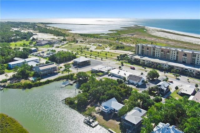 drone / aerial view with a water view and a beach view