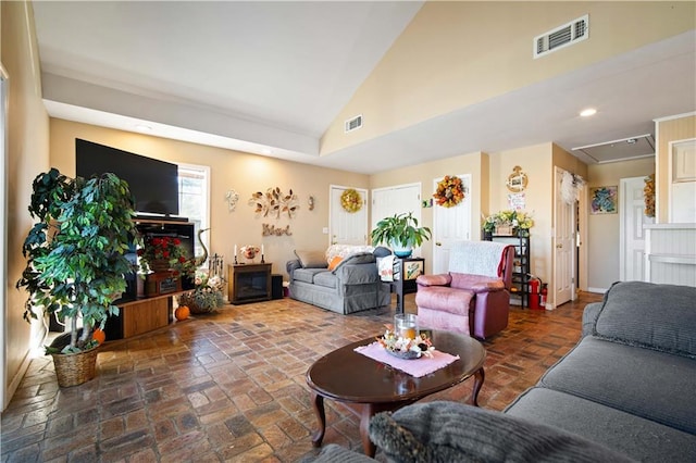 living room featuring high vaulted ceiling