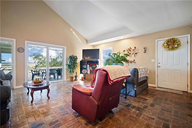 living room with high vaulted ceiling