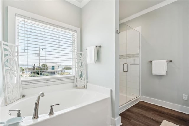 bathroom with wood-type flooring and separate shower and tub