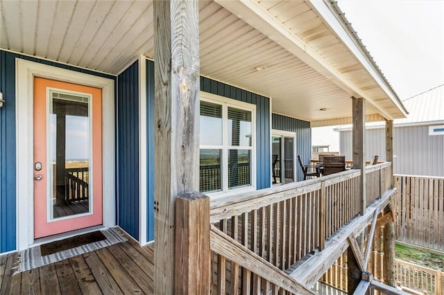 wooden terrace featuring covered porch