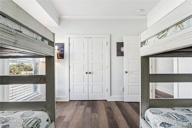 bedroom featuring ornamental molding, dark hardwood / wood-style floors, and a closet