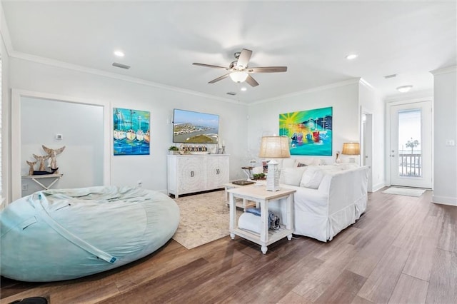 living room featuring crown molding, ceiling fan, and wood-type flooring