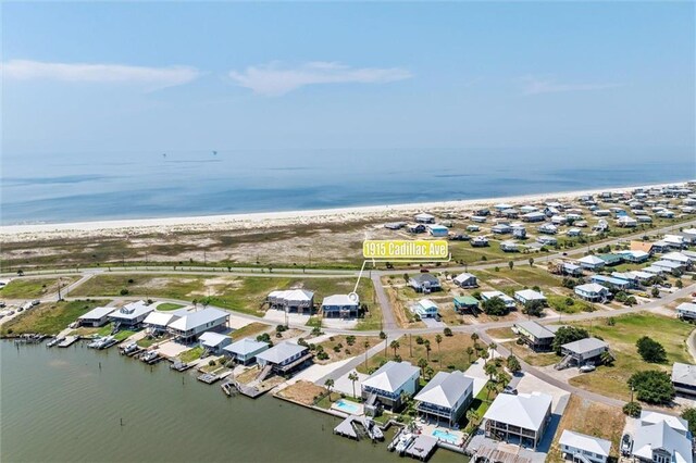 drone / aerial view featuring a water view and a view of the beach