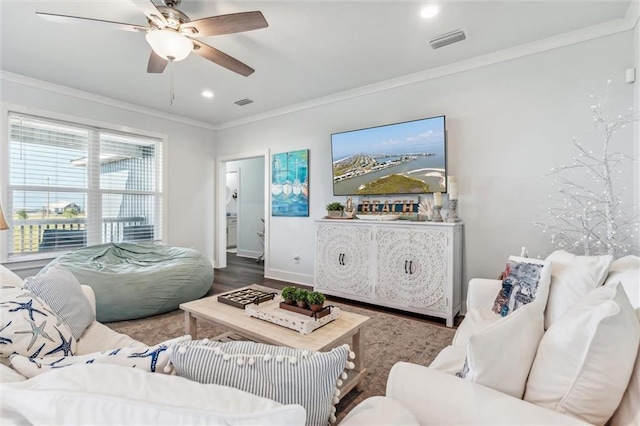 living room with crown molding, ceiling fan, and hardwood / wood-style flooring