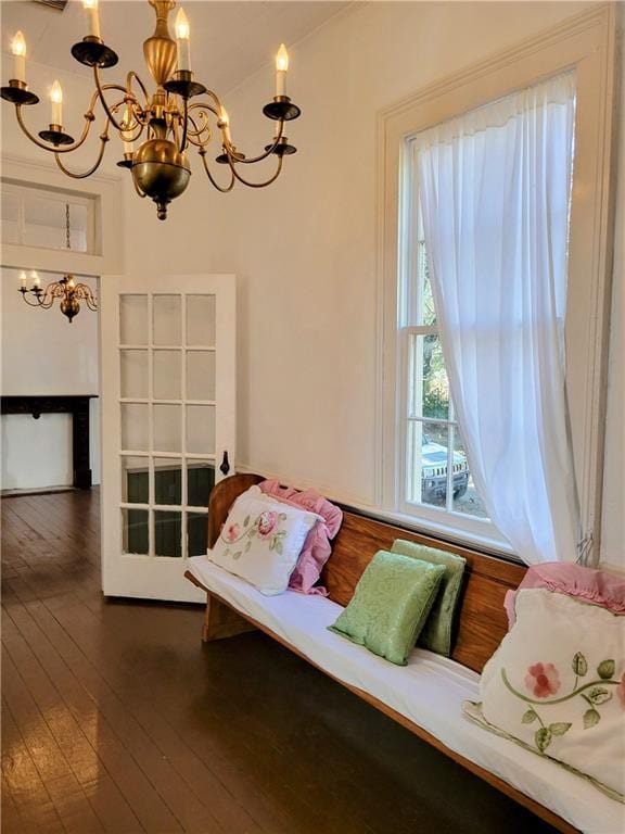 living area featuring an inviting chandelier and dark wood-type flooring