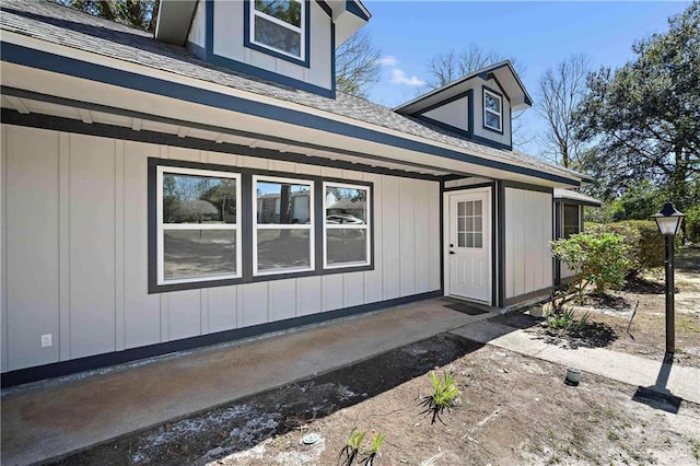 exterior space featuring a shingled roof