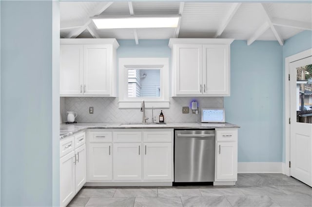 kitchen with light stone counters, white cabinets, dishwasher, and a sink