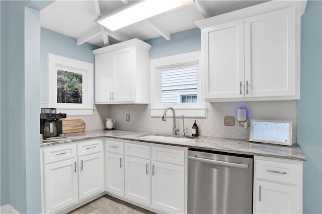 kitchen with light stone counters, a sink, white cabinets, dishwasher, and tasteful backsplash