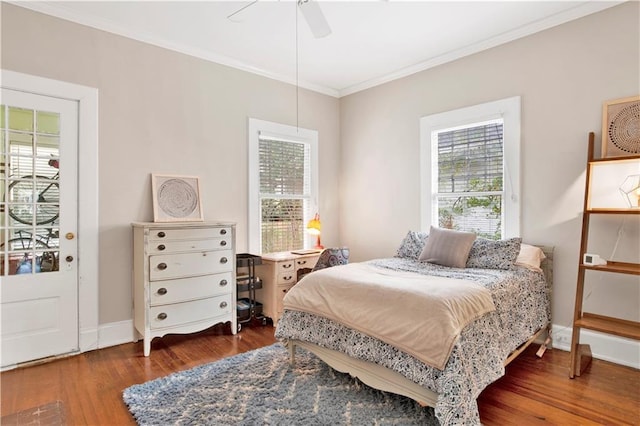 bedroom with multiple windows, wood finished floors, and crown molding