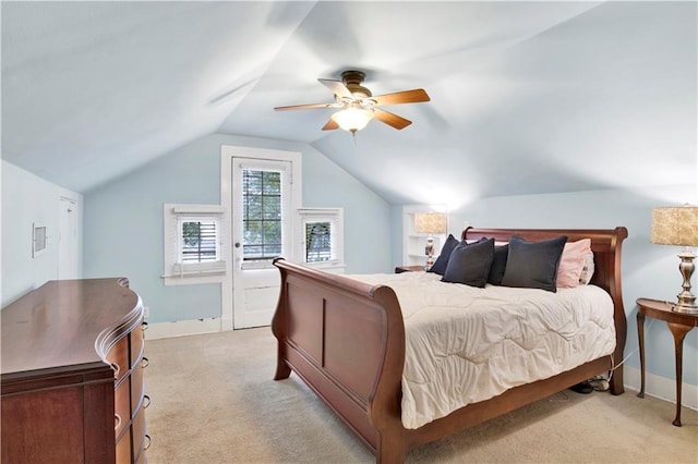 bedroom with light carpet, lofted ceiling, a ceiling fan, and baseboards