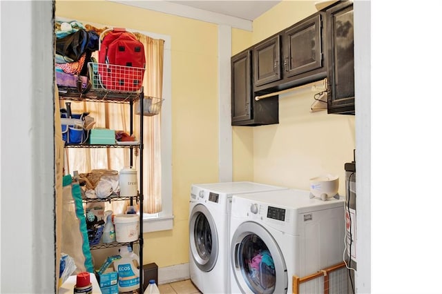56 Reed Ave N, Mobile, AL 36604 - laundry area with washing machine and dryer, cabinet space, and light tile patterned floors