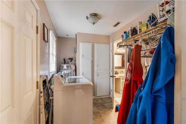 clothes washing area with separate washer and dryer