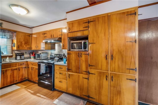 kitchen featuring crown molding, black electric range, and light hardwood / wood-style flooring