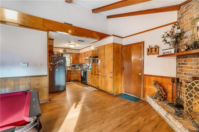 kitchen with light hardwood / wood-style flooring, wood walls, beamed ceiling, and appliances with stainless steel finishes