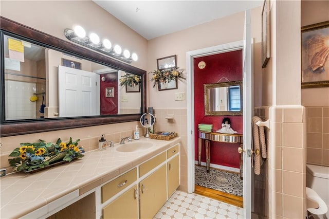 bathroom featuring tile walls and vanity