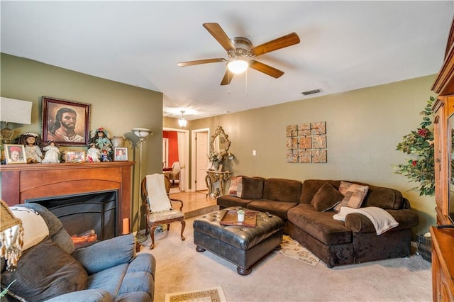 living room featuring light carpet and ceiling fan