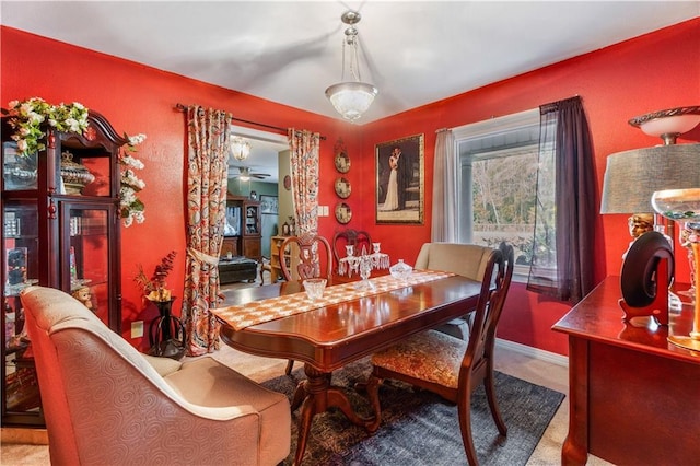 dining area featuring ceiling fan and carpet flooring