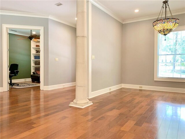 unfurnished room with ornamental molding, hardwood / wood-style flooring, and ornate columns