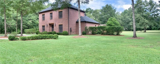 view of home's exterior with a yard